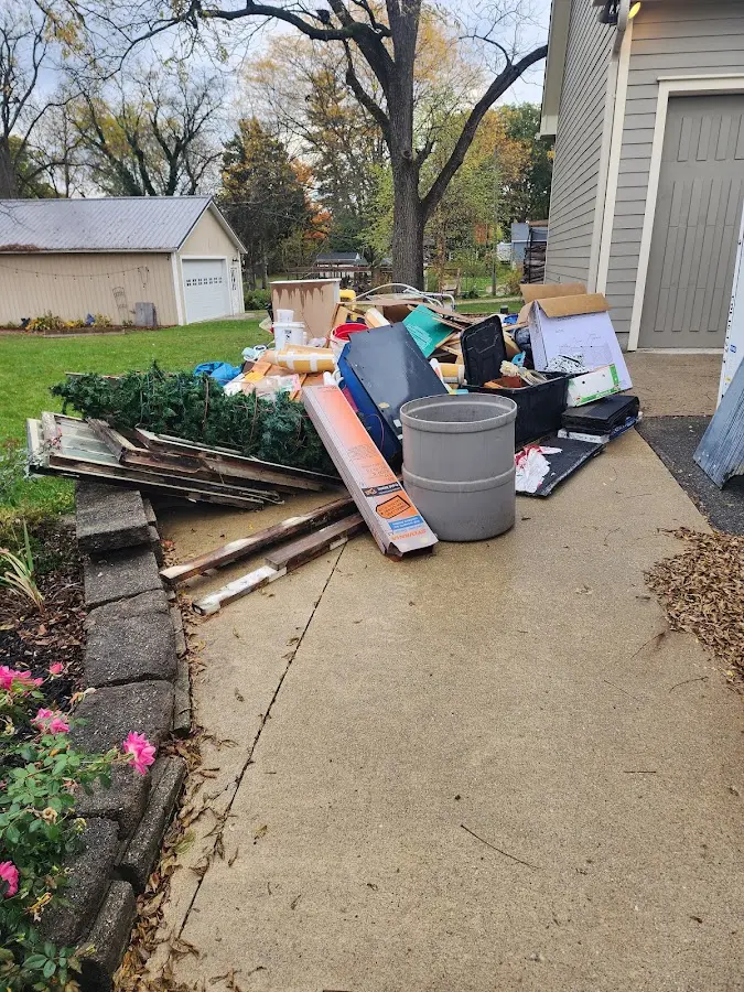 Dumpster being loaded with debris for 30 Yard Dumpster Rental in Ottawa Hills